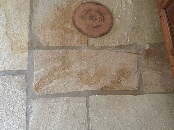 Sandstone floor is stained